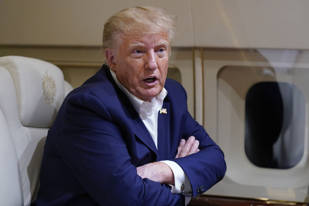 Former President Donald Trump speaks with reporters while in flight on his plane after a campaign rally at Waco Regional Airport, in Waco, Texas, March 25, 2023, while en route to West Palm Beach, Fla. (AP Photo/Evan Vucci, File)