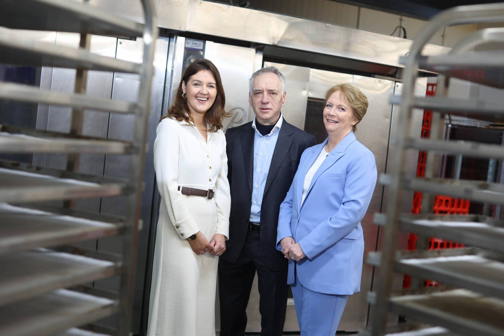 Deirdre O’Neill, Managing Director of Compass Ireland, Jennifer Mooney, Director of Glanmore Foods, and John Mooney, Managing Director of Glanmore Foods, shake hands to symbolise the acquisition of Glanmore Foods by Compass Ireland, expanding its footprint in food-services within the education sector and increasing the delivery of hot, nutritious meals to children across Ireland. Picture: Julien Behal Photography