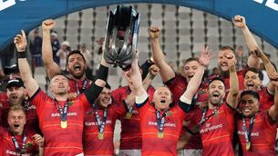 <p>RED REDEMPTION: Munster captain Peter O'Mahony, left, and Keith Earls lift the trophy as teammates celebrate after winning the United Rugby Championship Final match between DHL Stormers and Munster at DHL Stadium in Cape Town, South Africa. Pic: Nic Bothma/Sportsfile</p>