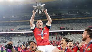 <p>LEGENDARY STATUS: Keith Earls of Munster is carried by teammates Malakai Fekitoa, left, and Antoine Frisch as they celebrate with the trophy after the United Rugby Championship Final. Pic: Nic Bothma/Sportsfile</p>