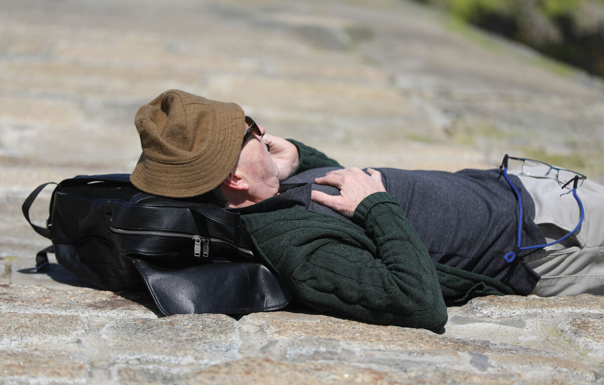 A man takes a phone call while relaxing in the sun during the hot weather in Seapoint. Picture: Leah Farrell / RollingNews.ie A man takes a phone call while relaxing in the sun during the hot weather in Seapoint. Picture: Leah Farrell / RollingNews.ie