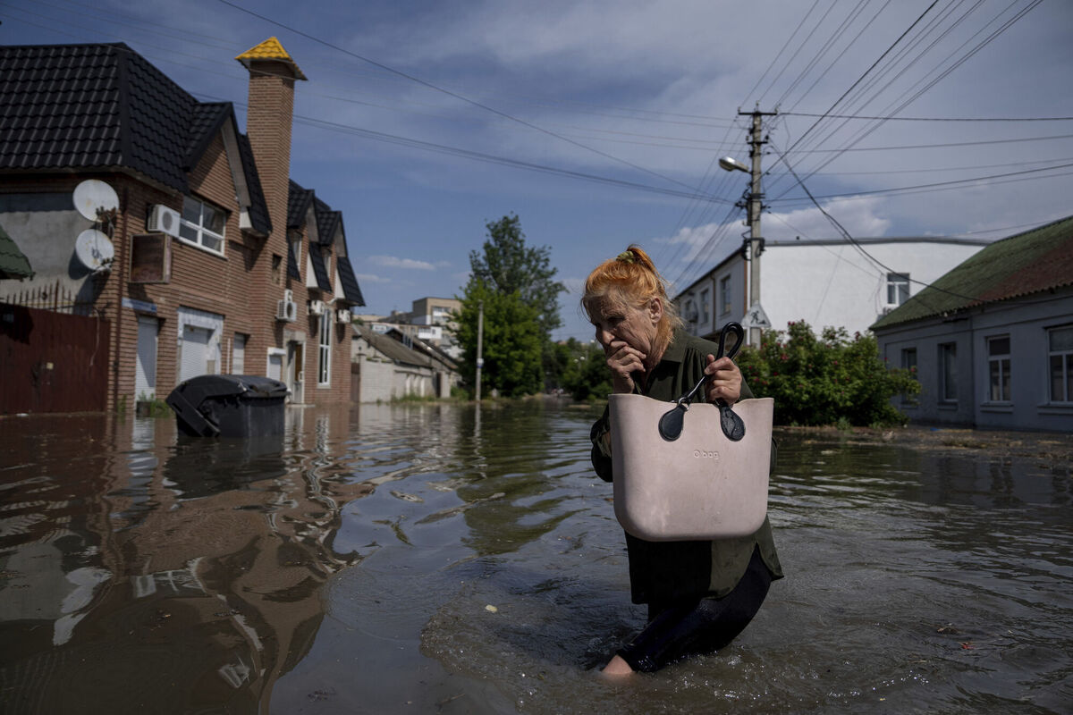 A local resident makes her way through a flooded road in the wake of the explosion at the Kakhovka dam in Kherson overnight. Picture: AP Photo/Evgeniy Maloletka A local resident makes her way through a flooded road in the wake of the explosion at the Kakhovka dam in Kherson overnight. Picture: AP Photo/Evgeniy Maloletka