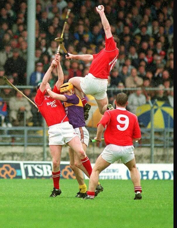 The iconic Teddy McCarthy image from the Irish Examiner archives of the 1993 league final against Wexford when McCarthy’s left knee was ten inches over the head of the Wexford player competing for the same ball