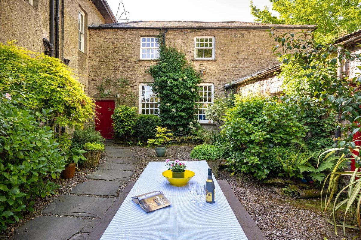 A courtyard area by the house. There's also a coach house and yard and barn and gate lodge with its own private garden