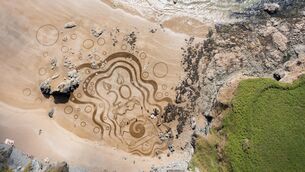 <p>As part of the 20th year anniversary of Clean Coasts, artist Sean Corcoran created a special sand art mural at Bunmahon Beach, Co Waterford. Picture: Cathal Noonan</p>