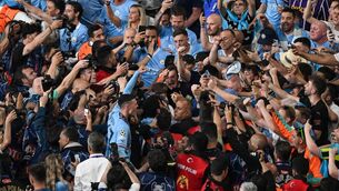 <p>DELIRIUM: Manchester City's midfielder Phil Foden celebrates with fans after winning the Champions League final. Pic: Yasin Akgul/AFP via Getty Images</p>
