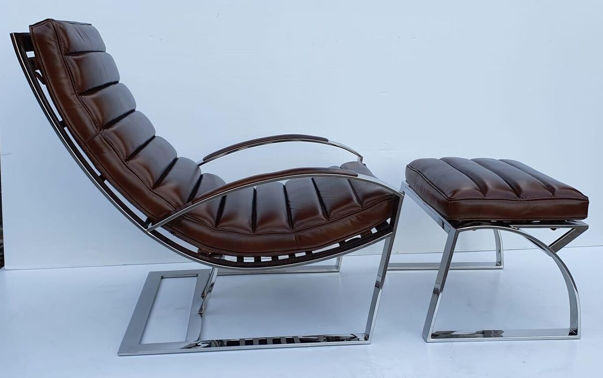 An Art Deco style walnut and chrome armchair and footstool at Victor Mee.