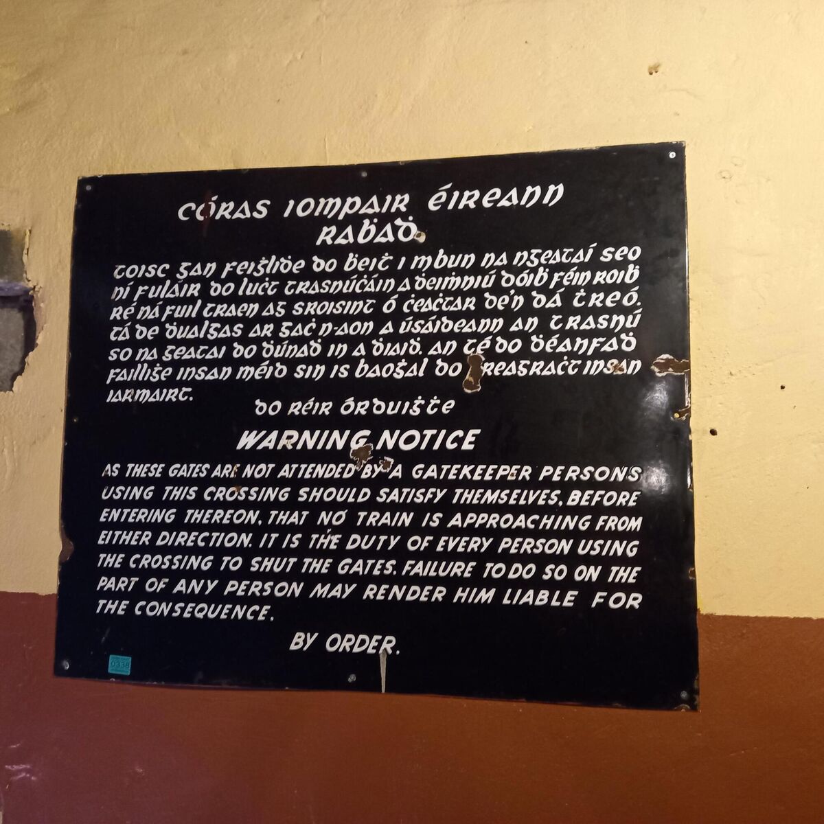 A bilingual level crossing sign at Aidan Foleys sale.