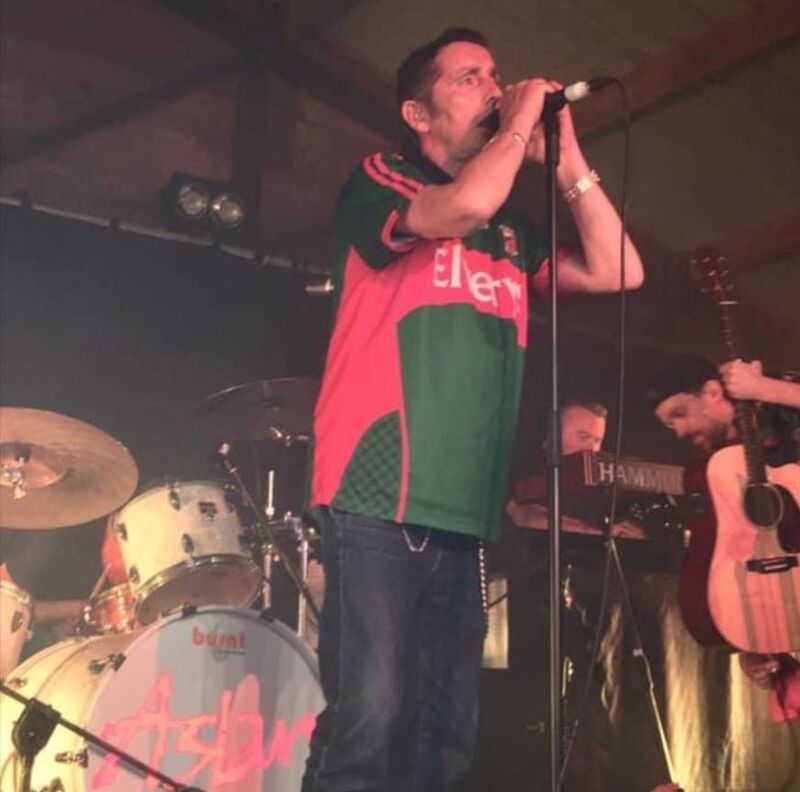Christy Dignam, a true-blue Dublin man, shocked his fellow Dubs and thrilled the Mayo crowd in equal measure when he came on stage at the Ballinrobe Festival in 2019 wearing the green and red. A Crazy World indeed! Christy Dignam, a true-blue Dublin man, shocked his fellow Dubs and thrilled the Mayo crowd in equal measure when he came on stage at the Ballinrobe Festival in 2019 wearing the green and red. A Crazy World indeed!