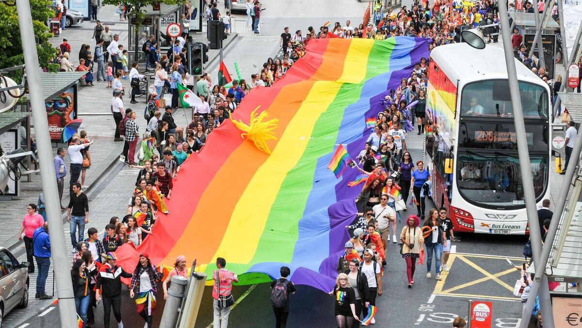 The Pride flag is held aloft in St Patrick's Street at the Cork Pride 2016 parade. Picture. John Allen