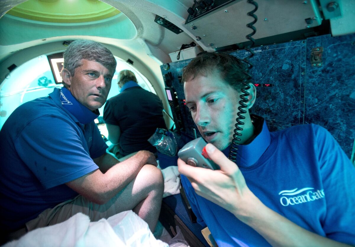 Submersible pilot Randy Holt, right, communicates with the support boat as he and Stockton Rush, left, CEO and Co-Founder of OceanGate, dive in the company's submersible, "Antipodes," about three miles off the coast of Fort Lauderdale, Fla., June 28, 2013. FIle Picture: AP Photo/Wilfredo Lee