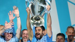 <p>Manchester City's Ilkay Gundogan celebrates with the Champions League trophy</p>