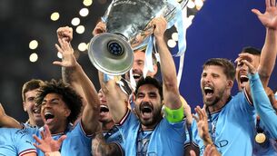 <p>GOING OUT ON TOP: Manchester City's Ilkay Gundogan lifts the Champions League trophy. Pic: PA</p>