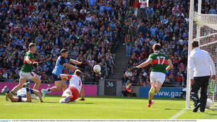 <p>KILLER SCORE: Colm Basquel of Dublin palms the ball past Mayo goalkeeper Colm Reape and Sam Callinan to the net for his and Dublin's second goal. Pic: Ray McManus/Sportsfile</p>