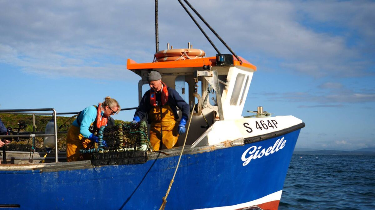 Niamh Ní Dhrisceoil hauling lobster pots with her father Pádraig Niamh Ní Dhrisceoil hauling lobster pots with her father Pádraig