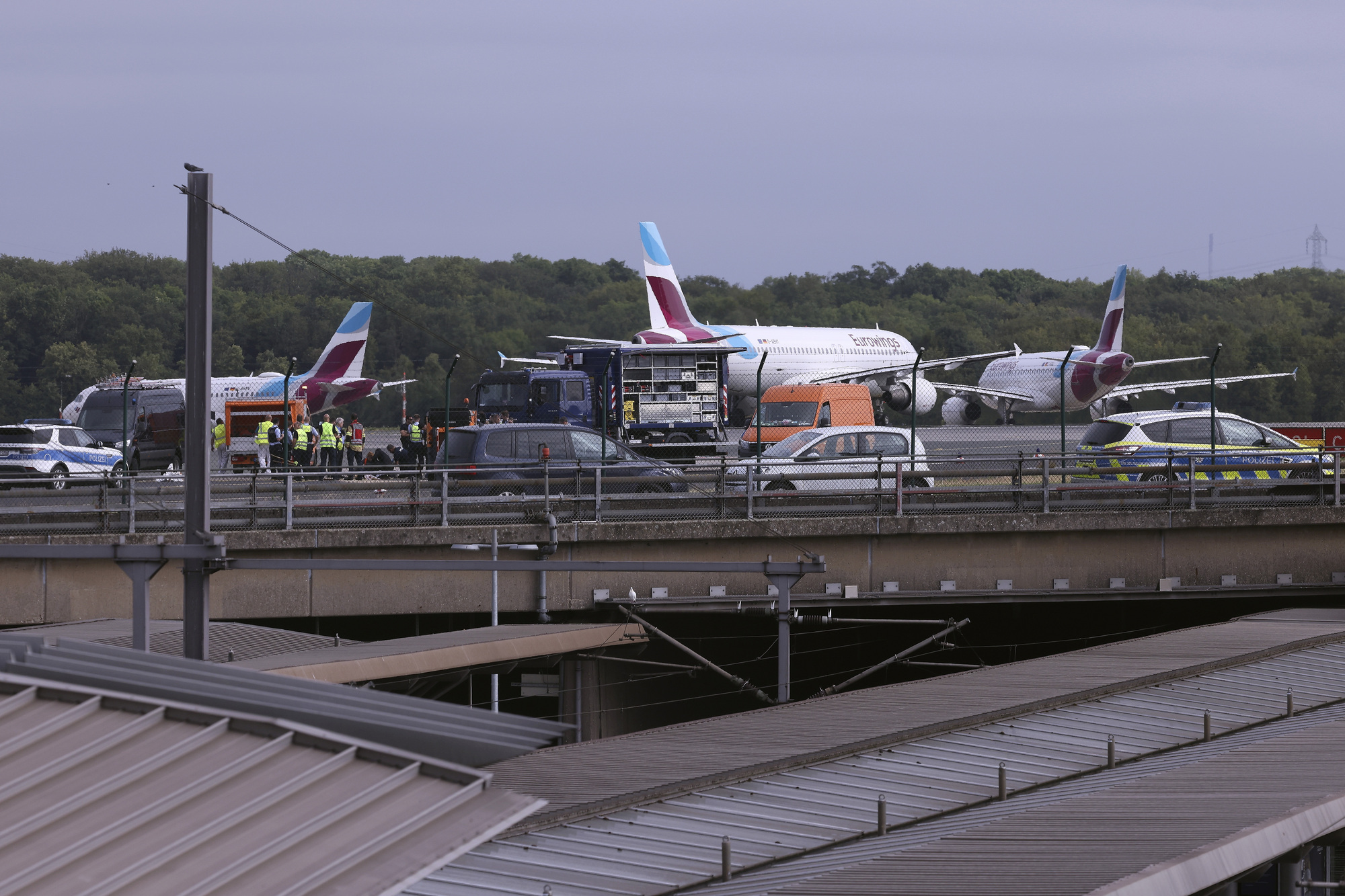Flights cancelled as climate activists block runway at German airport