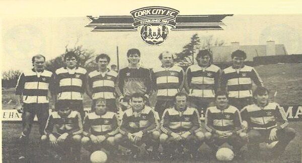 Terry McDermott (back right) lining up for Cork City in 1985. Back row: Trevor Parr, Clem Mahon, Liam Keane, Ian Douglas, Donal Madden, Stuart Ashton, McDermott. Front row: Dave O’Connor, Ginger Healy, Bob Woodruff, Dave Waters, Paul Crowley, Ian Hennessy. Picture via @TWelchTV3