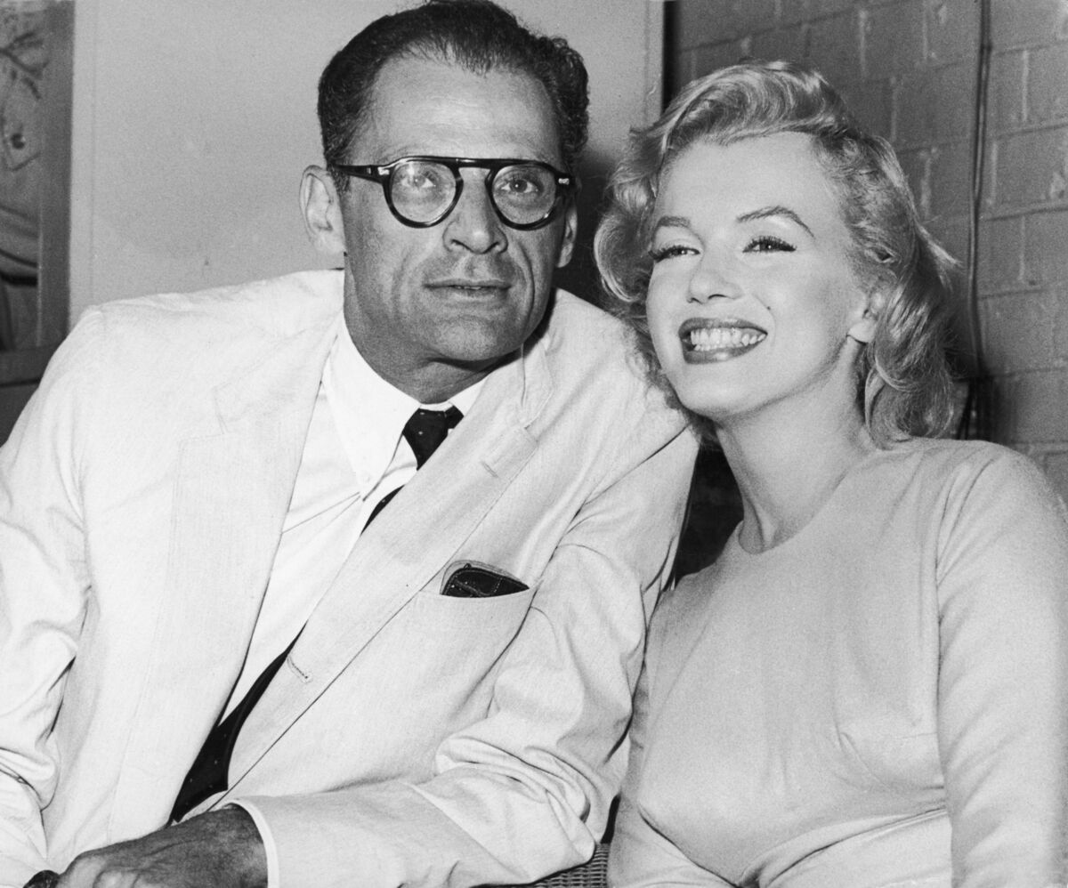 American actress Marilyn Monroe (1926 - 1962) with her husband, playwright Arthur Miller at London Airport, 14th July 1956. Monroe is in London to begin filming 'The Prince and the Showgirl' with Laurence Olivier. (Photo by Fox Photos/Hulton Archive/Getty Images)