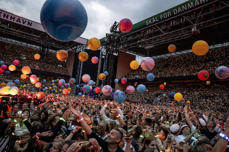 Audience members watch Coldplay perform at Parken Stadium in Copenhagen, Denmark. Picture: AP Audience members watch Coldplay perform at Parken Stadium in Copenhagen, Denmark. Picture: AP