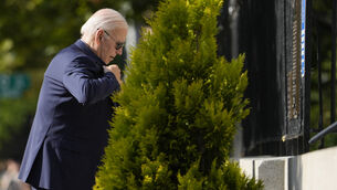 President Joe Biden adjusts his jacket after putting it on as he arrives at Holy Trinity Catholic Church in the Georgetown section of Washington (Manuel Balce Ceneta/AP)