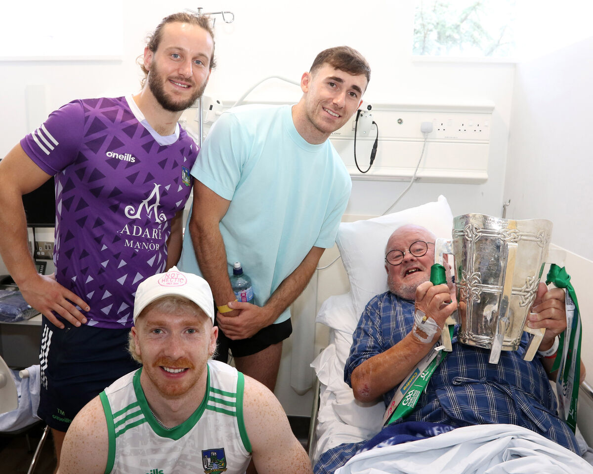 Limerick hurlers Cian Lynch, Tom Morrissey and Barry Nash with inpatient Pa Buckley, who was delighted to get his hands on the Liam MacCarthy Cup. Picture: Brendan Gleeson