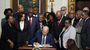US President Joe Biden signs a proclamation to establish the Emmett Till and Mamie Till-Mobley National Monument, in the Indian Treaty Room at the White House (Evan Vucci/AP/PA)