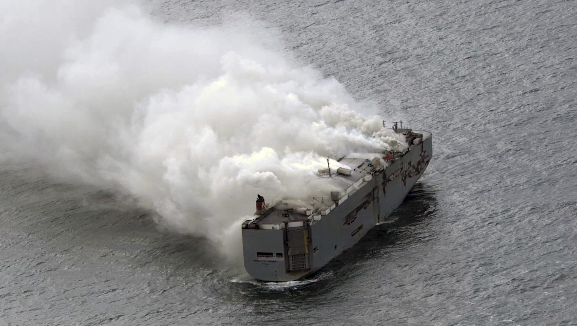 Crew member dies as fire on ship carrying 3,000 cars burns out of control