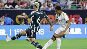 <p>FIRST OF MANY? Real Madrid’s Jude Bellingham, right, chips the ball over Manchester United defender Lisandro Martinez for a goal during the first half against Manchester United Pic: Michael Wyke, AP</p>