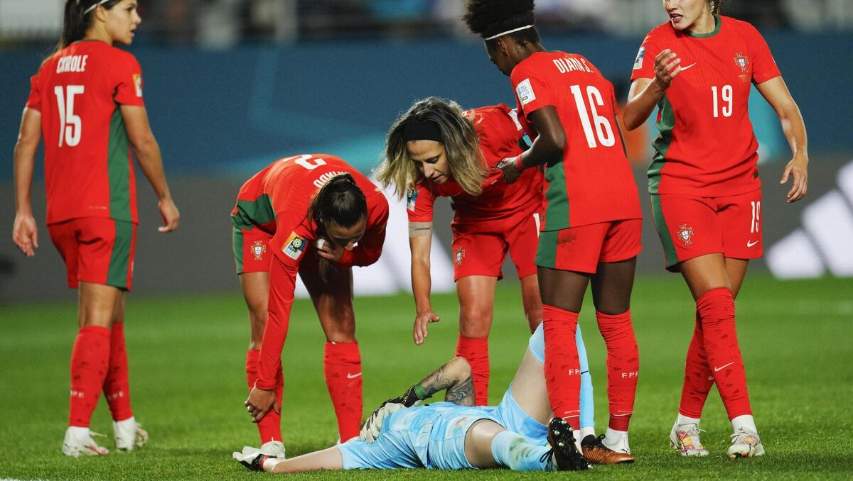 Portugal players check on teammate and goalkeeper Ines Pereira. (AP Photo/Abbie Parr)