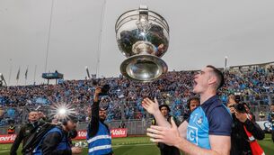 <p>UP, UP, AND AWAY: Dublin’s Brian Fenton celebrates with the Sam Maguire. Pic: ©INPHO/James Crombie</p>