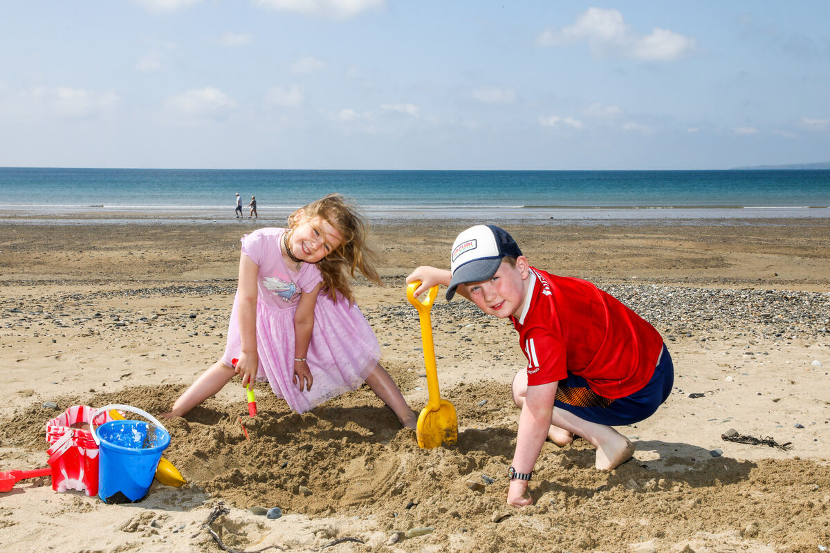 Sadhbh and Hugh Kelleher from Ballincollig digging in the sand on a bright summer morning at Garrylucas Beach, Co Cork, on June 6. Picture: David Creedon