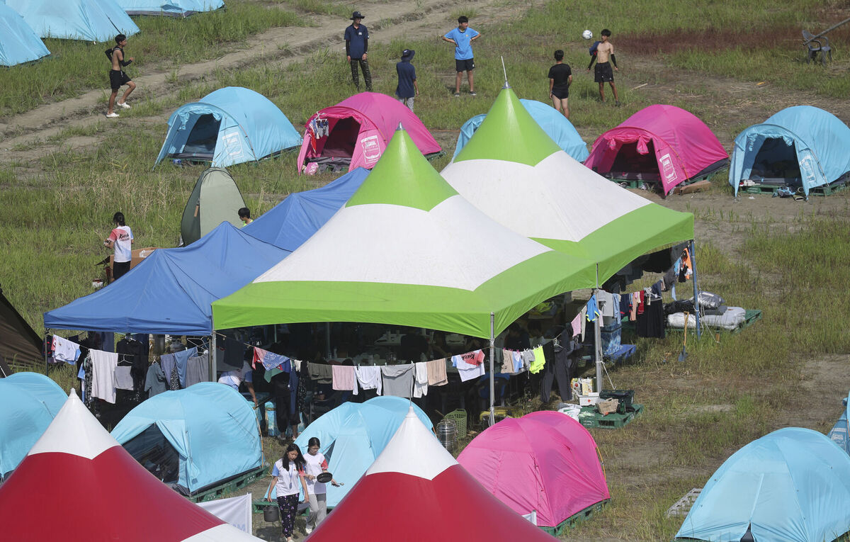 Tents are pitched at a scout camping site during the World Scout Jamboree in Buan, South Korea, Friday, Aug. 4, 2023. More than 100 people were treated for heat-related illnesses at the World Scout Jamboree being held in South Korea, which is having one of its hottest summers in years. (Choe Young-soo/Yonhap via AP) Tents are pitched at a scout camping site during the World Scout Jamboree in Buan, South Korea, Friday, Aug. 4, 2023. More than 100 people were treated for heat-related illnesses at the World Scout Jamboree being held in South Korea, which is having one of its hottest summers in years. (Choe Young-soo/Yonhap via AP)