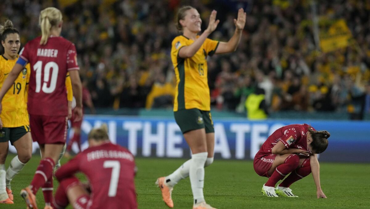 Players of Denmark react after their loss.