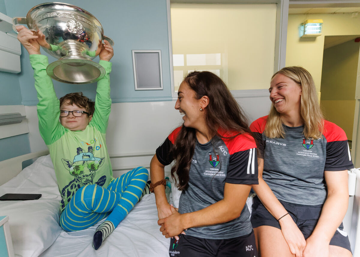 Cork's Amy O’Connor and Izzy O’Regan visiting 15-year-old Daniel McCarthy from Gurranabraher in Cork City during a visit to Temple Street Hospital, Dublin. Picture: James Crombie/INPHO