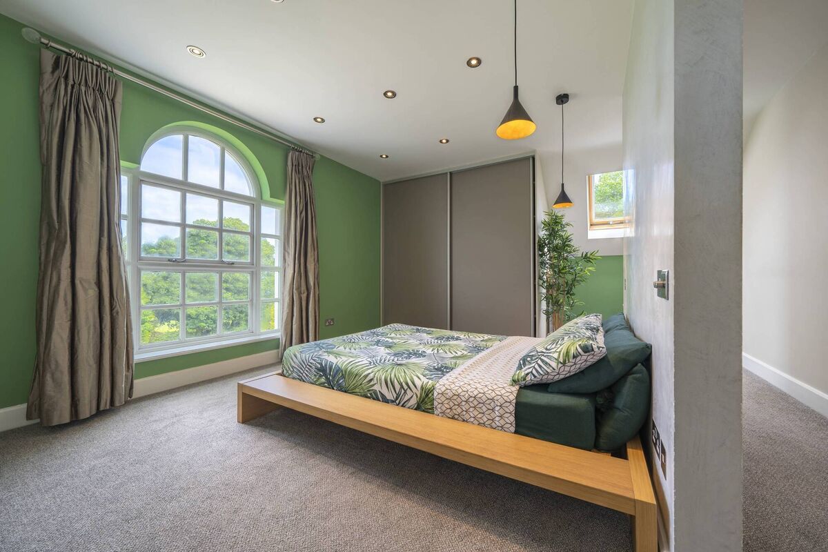 Main bedroom with original 'Venetian-style' arched window