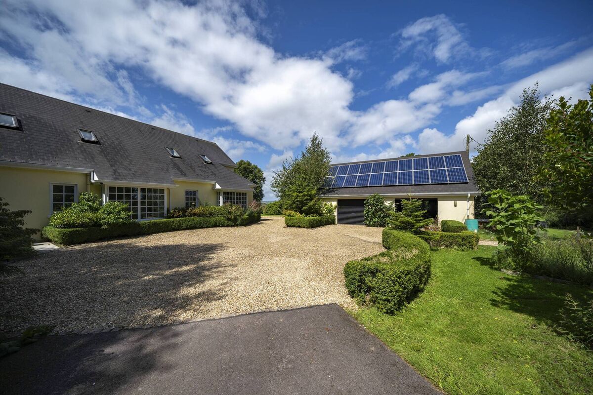 Ballygroman: approach, with large garage with solar panels helping the 3,800 s ft home get an A3 BER