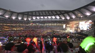 Attendees of the World Scout Jamboree watch a K-Pop concert after the closing ceremony of the World Scout Jamboree (Pool via AP)