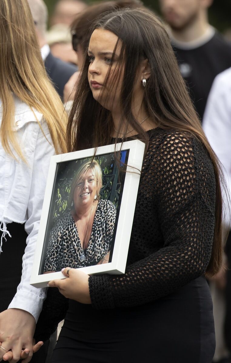 A family member carries a photo of Detective Garda Deirdre Finn at her funeral in St John the Evangelist Church, Ballinteer. Picture: Colin Keegan, Collins Dublin