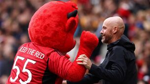 <p>FRED THE RED: Manchester United's Dutch manager Erik ten Hag plays with the team mascot. (Photo by DARREN STAPLES/AFP via Getty Images)</p>