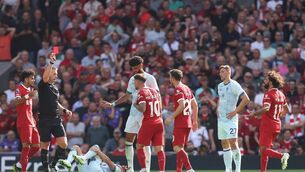 <p>RED CARD: Referee Thomas Bramall shows a red card to Alexis Mac Allister of Liverpool following a challenge on Ryan Christie of AFC Bournemouth (on floor). Pic: George Wood/Getty Images</p>