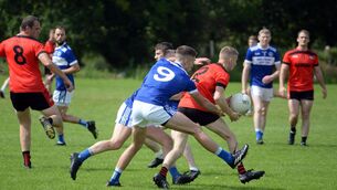 <p>SURROUNDED: Dara Crowley of Kenmare Shamrocks tackled by Templenoe's Adrian Spillane and Michael Hallissey during the Kerry Club SFC clash in Kenmare. Pic: Don MacMonagle</p>