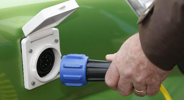 An electric car being charged at a charging point.