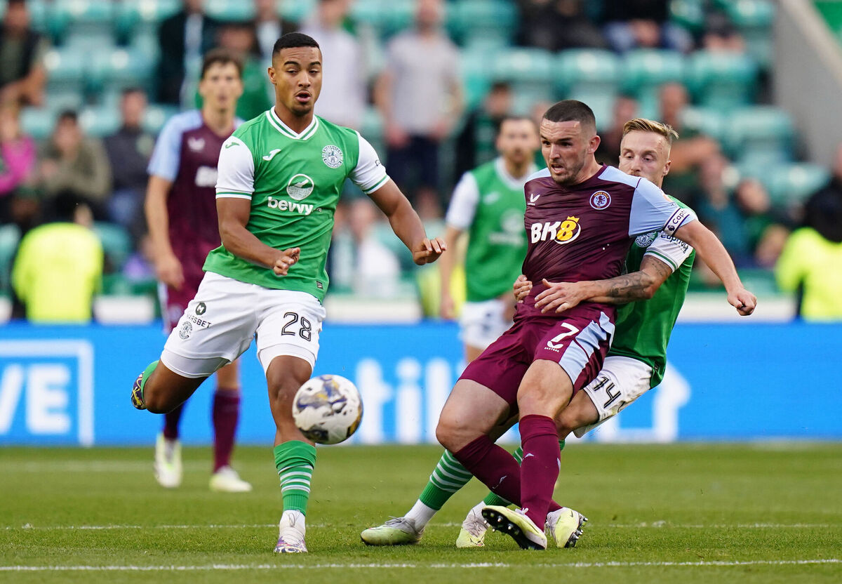 Aston Villa's John McGinn battles for the ball with Hibernian's Allan Delferriere.