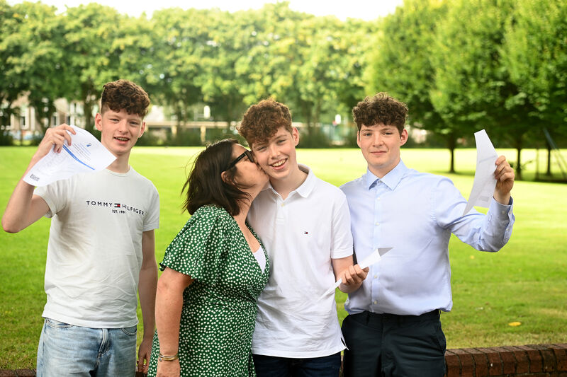  Proud mum Martina Lee with sons......Twin brothers Evan (left) and (right) Cameron Lee with younger brother Isaac Lee, from Douglas, Cork. The trio returned to Presentation Brothers College, Cork to meet schoolfriends and teachers after their picked up their results. Picture: Larry Cummins