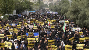 <p>Worshippers carry anti-US and Israel placards in a protest against Sweden after the Nordic nation allowed an Iraqi man to desecrate the Quran. Picture: AP Photo/Vahid Salemi</p>