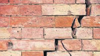 Deep crack in old brick wall - concept image