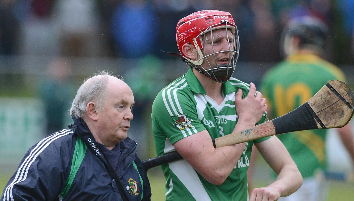 Cork hurler Lorcán McLoughlin in the company of Kanturk team physio Seamus Lynam forced out of the action with a shoulder injury against Castlelyons in the Co. Premier IHC at Castletownroche. Picture John Tarrant