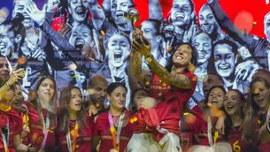 <p>Jennifer Hermoso holds the trophy aloft as she and her team-mates celebrate their Women's World Cup final win. In the background is Spain's soccer chief Luis Rubiales of whom Hermoso said: 'At no time did I consent to the kiss he gave me.' Picture: Manu Fernandez/AP</p>