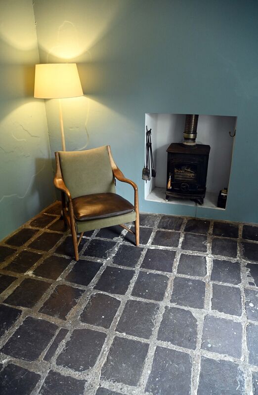 The middle room is a little snug, inviting cosy evenings beside the solid fuel stove. 