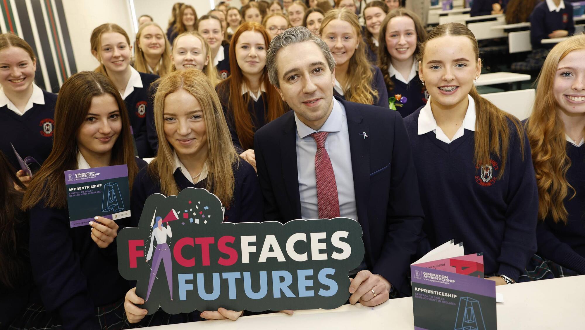 Simon Harris, Minister for Further and Higher Education, with students from Our Lady's School Terenure, Dublin, hosting a Q&A initiative promoting apprenticeship opportunities in Ireland. 